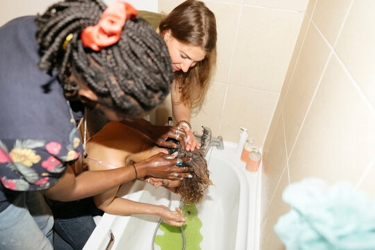Friends washing Woman's Hair
