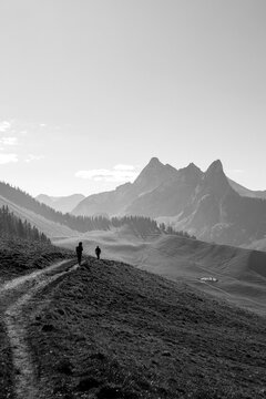 Impressive landscape, two people walking slowly on a path.