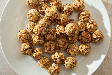A top down view of a pile of granola balls, on a plate.