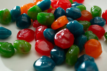 A view of a pile of juicy rainbow candy, on a plate.