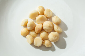 A top down view of a pile of macadamia nuts.