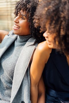 Two Confident Women in Stylish Outfits Embracing