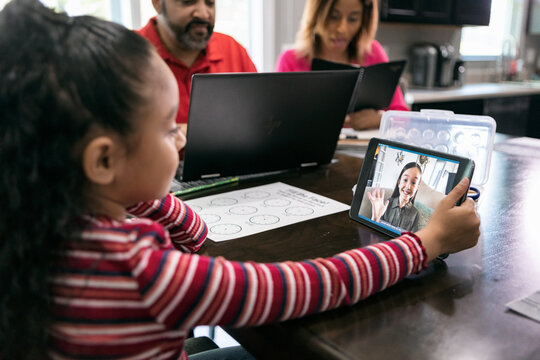 Home: Girl Has Video Call With Friend To Do Homework During Pand - Powered by Adobe