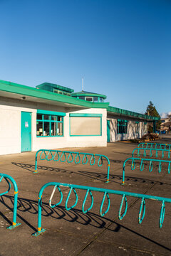 Bicycle Racks Outside a Modest Building on a Sunny Day