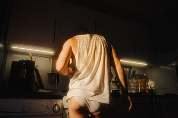 Man Preparing Breakfast in a Cozy Kitchen During Morning Light