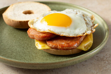 A view of a gluten-free, dairy-free Spam breakfast sandwich bagel.
