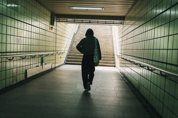 Woman Walking Through Subway Passage