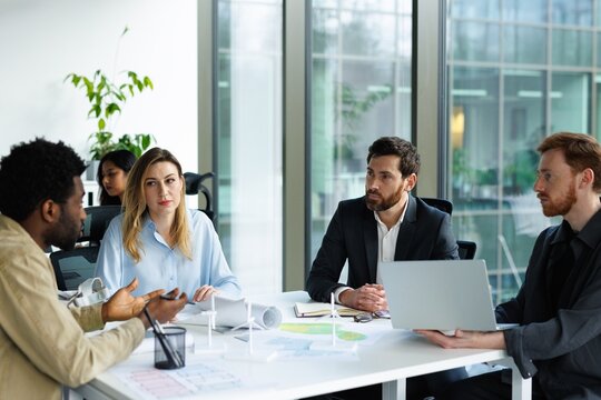Architects listening colleague telling about new residential project
