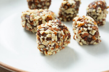 A closeup view of some almond date rolls, on a plate.