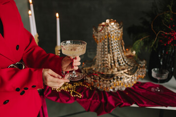 Festive Christmas table with hands holding sparkling champagne.