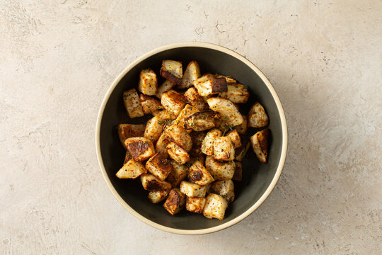 A top down view of a bowl of roasted turnips.