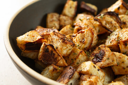 A closeup view of a bowl of roasted turnips.