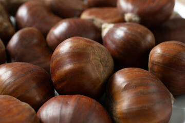 A closeup view of a pile of chestnuts.