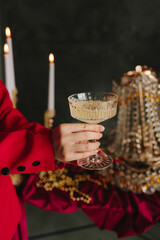 Holiday celebration with hands holding champagne over festive table.