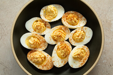 A top down view of plate of deviled eggs.