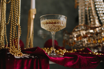 Festive champagne on Christmas table with sparkling ornaments.