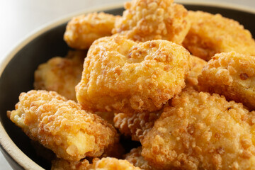 A closeup view of a bowl of gluten-free chicken nuggets.