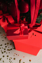 Festive red presents under Christmas tree. Presents under Christmas tree with new year decoration.
