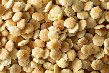 A top down view of a pile of oyster crackers, as a background.