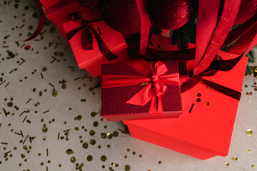 Celebrate Christmas with red presents under sparkling tree lights.