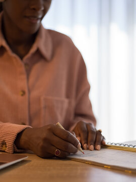 Woman highlighting sum while budgeting 