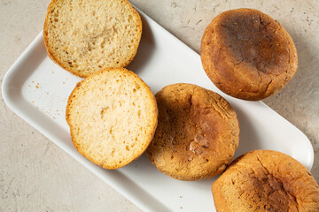 A top down view of a pile of dairy-free, gluten-free English muffins.