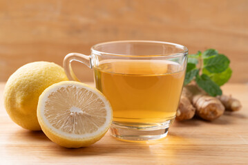 Lemon and ginger tea in cup glass with mint leaf, Healthy hot drink