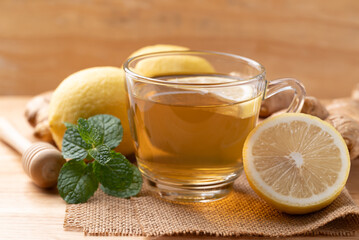 Lemon, ginger and honey tea in cup glass with mint leaf, Healthy hot drink
