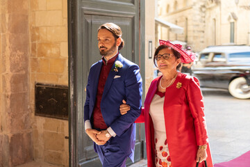 A groom with his mother during a wedding ceremony