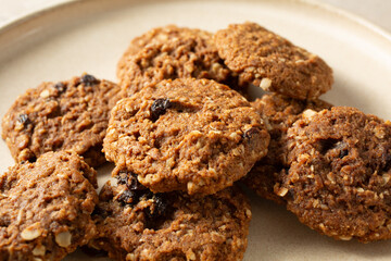 A view of a pile of gluten-free, dairy-free soft oatmeal raisin cookies.