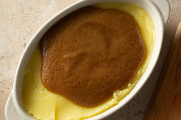 A top down view of a bowl of gluten-free, dairy-free mashed potatoes and gravy.