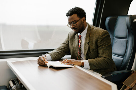 Reading a Book on a Train During a Quiet Journey