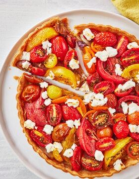 Colorful Heirloom Tomato Tart with Goat Cheese on a White Plate