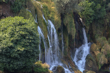Image of Kravice Waterfall in Herzegovina from August 24, 2025, featuring cascading water, greenery, and rugged rock formations.