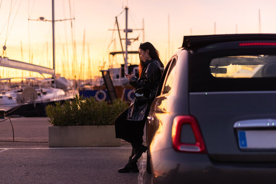 Woman using smartphone at harbor 