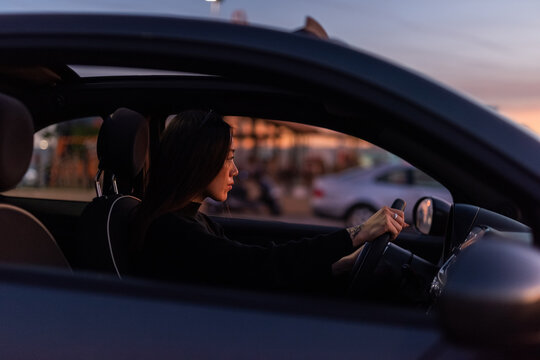 Focused woman driving car 