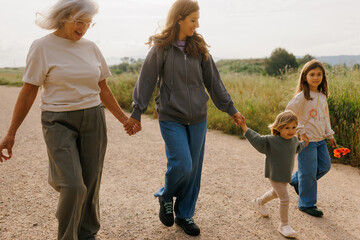 Three generations walking together on a country road