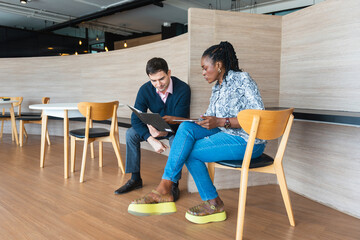 Multicultural Business Colleagues Discussing Project Strategy in Office Lounge, Male and Female...