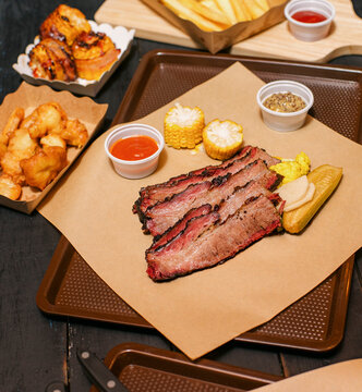 Delicious BBQ Feast With Fries, Sides, and Desserts at a restaurant