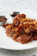 A view of a plate of fried chicken.
