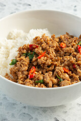 A view of a bowl of pad krapow chicken.
