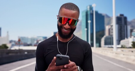 Technology, fitness or happy man on road for workout, streaming music or check start time for run. Sunglasses, earphones or black person outdoor with smart watch for exercise progress, phone or space - Powered by Adobe