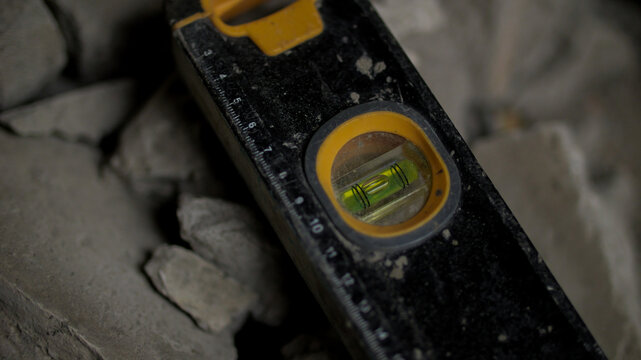 Construction level tool on rubble