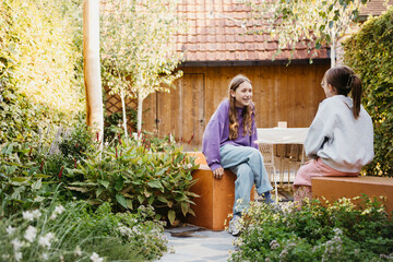 two kids hanging out in their modern garden