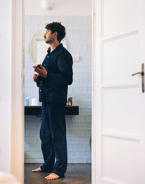 Man in Casual Clothing Standing in the Bathroom Early Morning