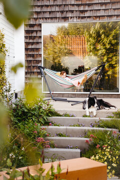 Backyard Moment Between Girl and Border Collie in Garden Retreat
