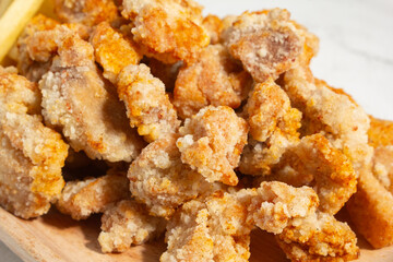 A closeup view of a plate of popcorn chicken.