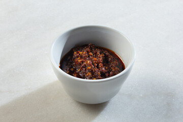A view of a bowl of Chinese hot sauce.