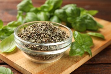Dry basil leaves, fresh ones and bowl on wooden table, closeup