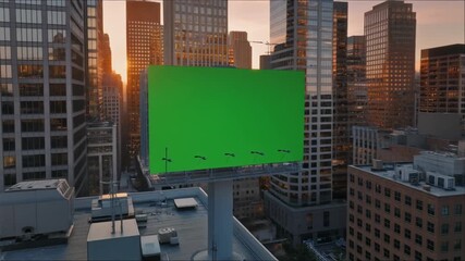 Dynamic city skyline with a customizable green screen billboard at sunset, perfect for impactful urban advertising campaigns and innovative brand promotions